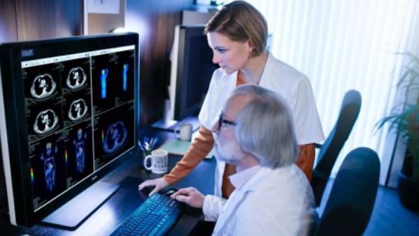 Doctor and nurse looking at medical computer screen